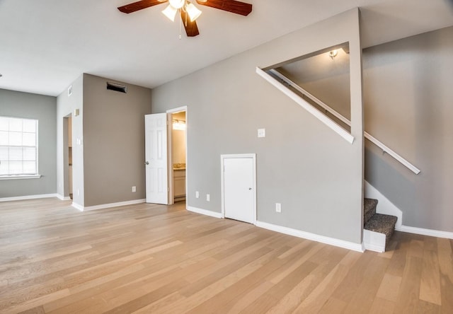 unfurnished living room featuring ceiling fan and light wood-type flooring