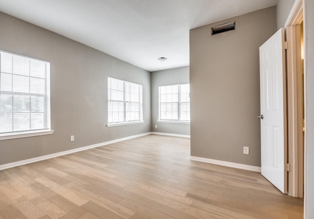 spare room featuring light hardwood / wood-style flooring