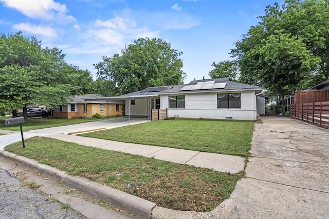 view of front of property featuring driveway, fence, a front lawn, and an attached carport