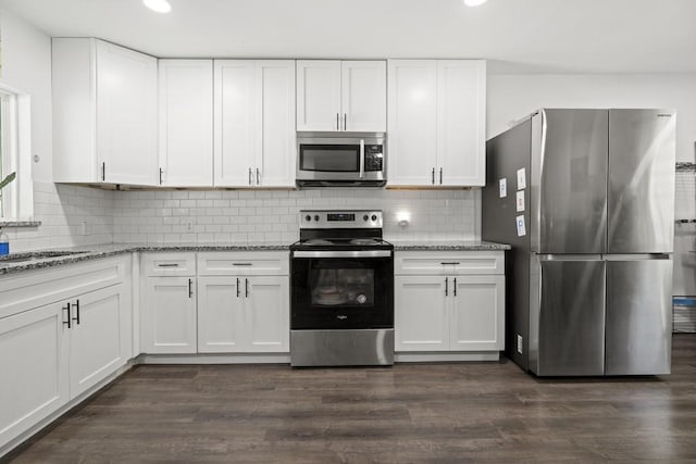 kitchen featuring dark wood-style floors, appliances with stainless steel finishes, and white cabinetry