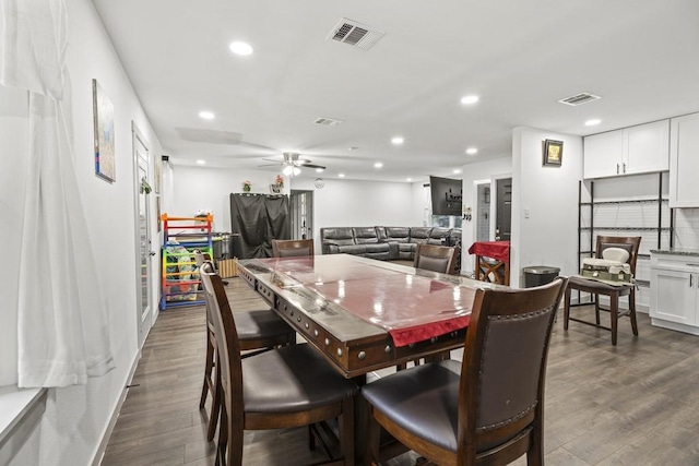 dining space with visible vents, dark wood-type flooring, and recessed lighting