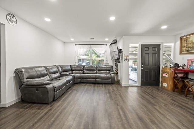 living area featuring baseboards, wood finished floors, and recessed lighting