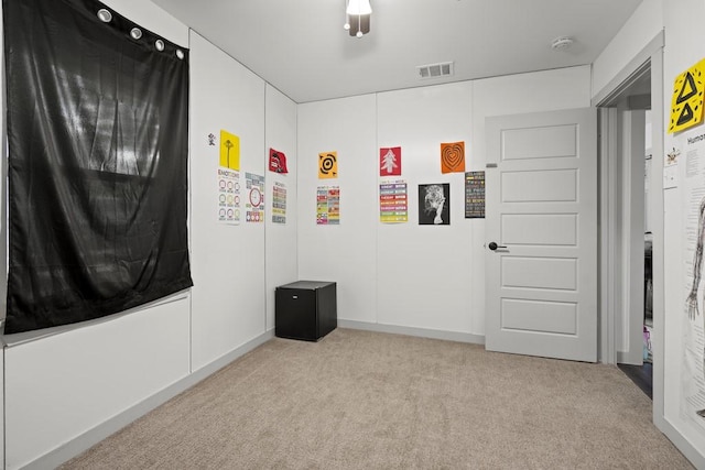 unfurnished bedroom featuring carpet and visible vents