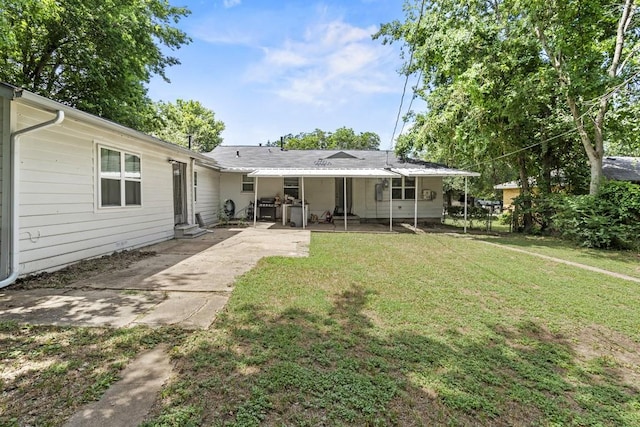 rear view of property with a patio area and a yard