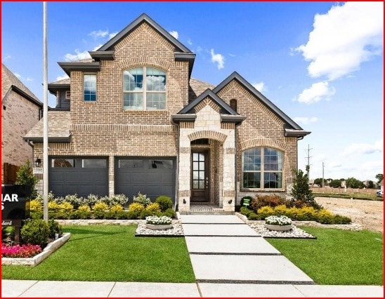 view of front facade with a garage and a front lawn