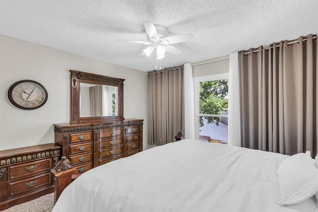 bedroom featuring ceiling fan and a textured ceiling