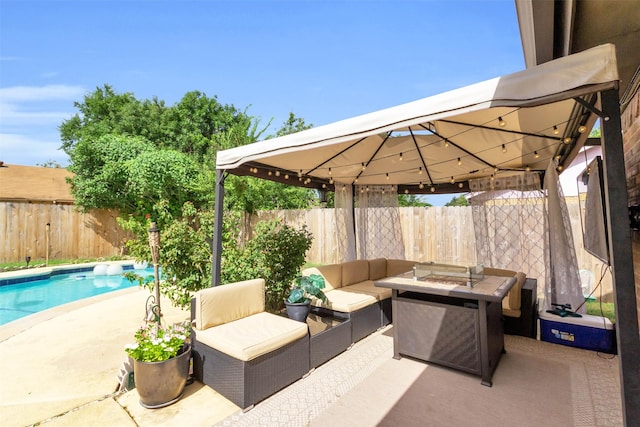 view of patio with a fenced in pool, a gazebo, and an outdoor living space with a fire pit