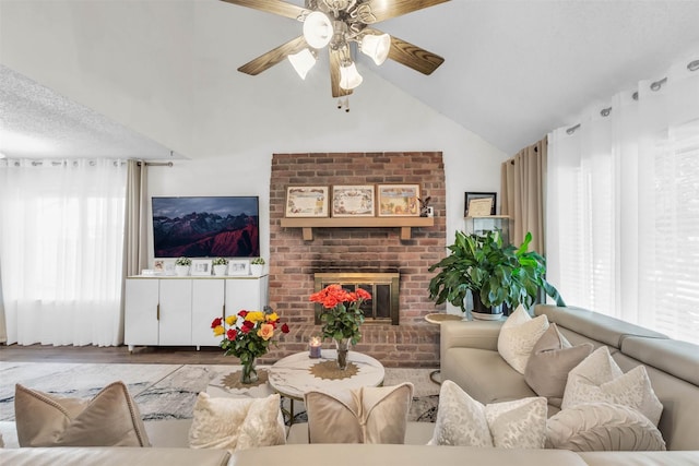 living room with lofted ceiling, a fireplace, ceiling fan, and light wood-type flooring