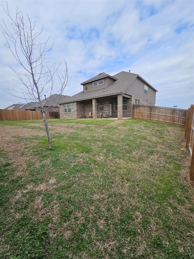 rear view of house with a yard