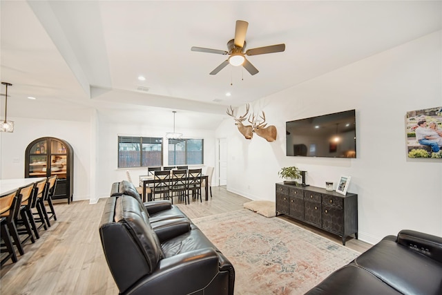 living room with ceiling fan and light wood-type flooring