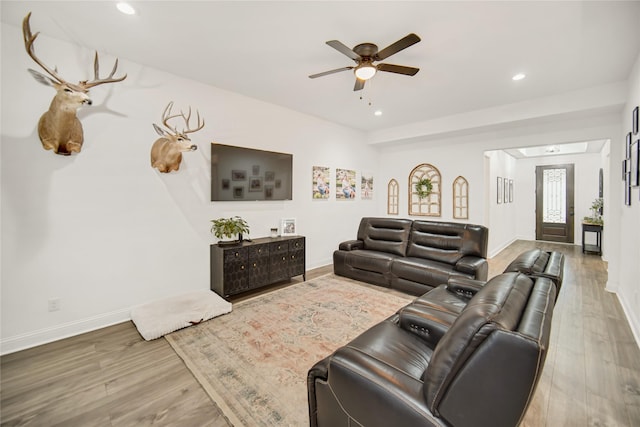 living room featuring hardwood / wood-style flooring and ceiling fan