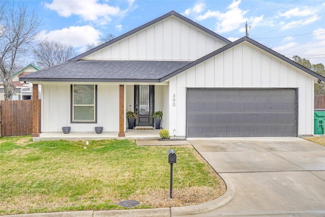 view of front of property with a garage, a front yard, and a porch