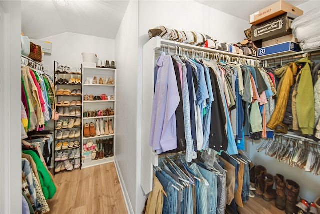 spacious closet with vaulted ceiling and light wood-type flooring