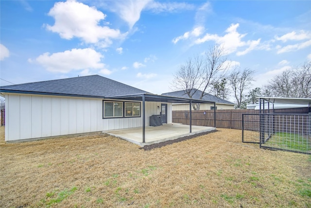 back of house with a yard and a patio