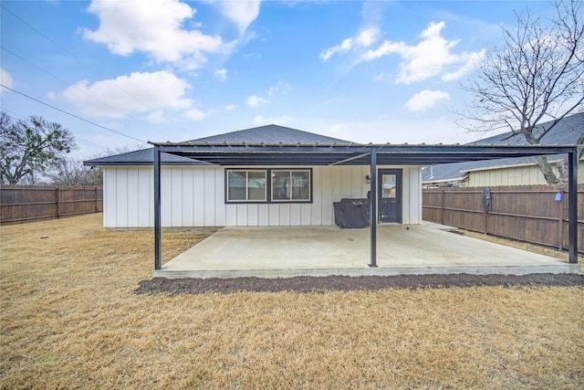 back of house with a yard and a patio