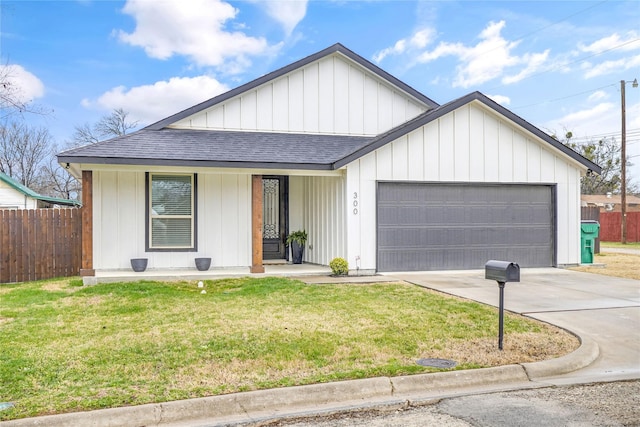 view of front of property featuring a garage and a front yard