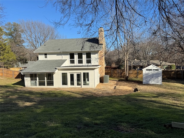 12009 Saddlehorn Ln, Mansfield, TX 76063 - back of property with french doors, a sunroom, a chimney, a fenced backyard, and a shed