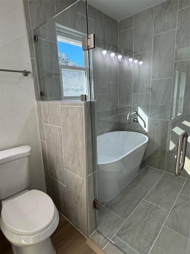 12009 Saddlehorn Ln, Mansfield, TX 76063 - full bath with a freestanding tub, wood finished floors, and a tile shower