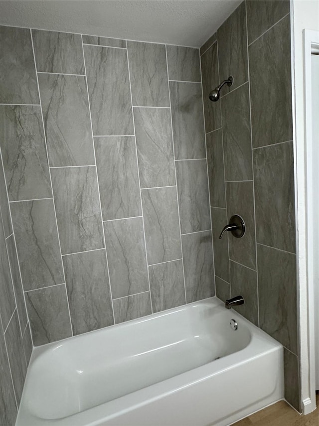 12009 Saddlehorn Ln, Mansfield, TX 76063 - full bathroom with shower / bath combination, a textured ceiling, and wood finished floors