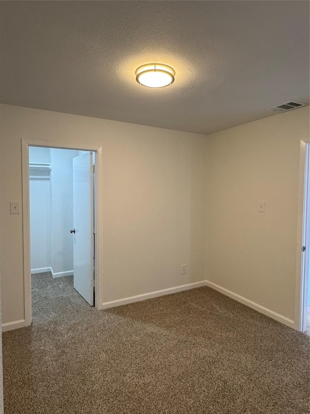 12009 Saddlehorn Ln, Mansfield, TX 76063 - empty room featuring carpet floors and a textured ceiling