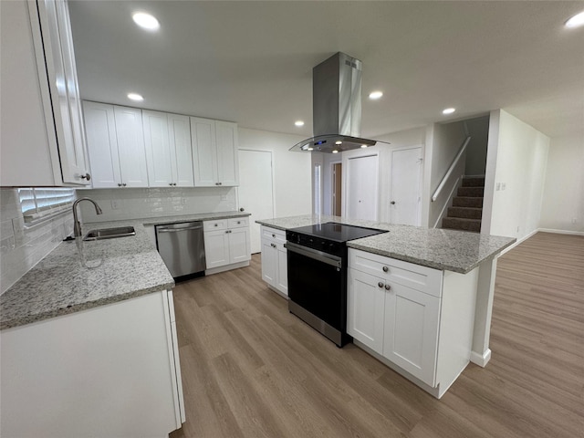 12009 Saddlehorn Ln, Mansfield, TX 76063 - kitchen with stainless steel dishwasher, electric stove, island range hood, a sink, and light wood finished floors