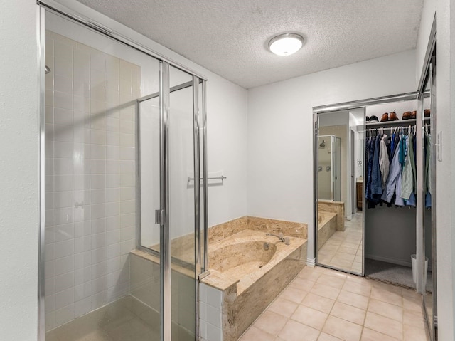 bathroom with shower with separate bathtub, tile patterned flooring, and a textured ceiling