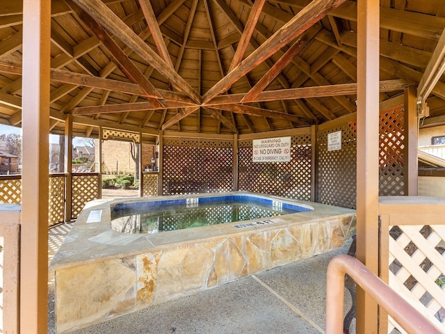 exterior space with a community hot tub and a gazebo