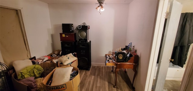 interior space featuring wood-type flooring and ceiling fan