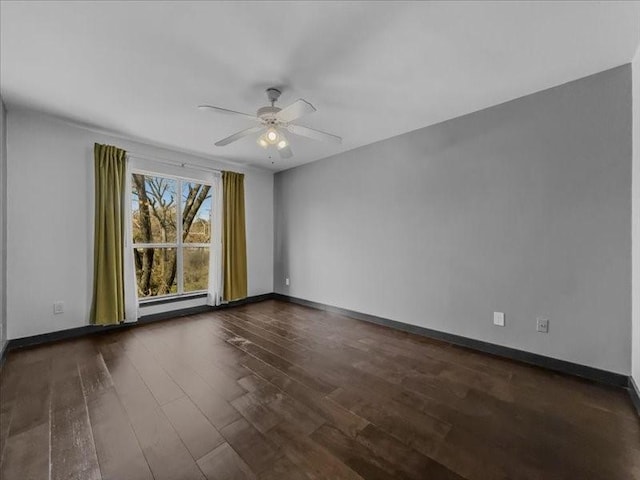 spare room with a baseboard heating unit, dark hardwood / wood-style floors, and ceiling fan