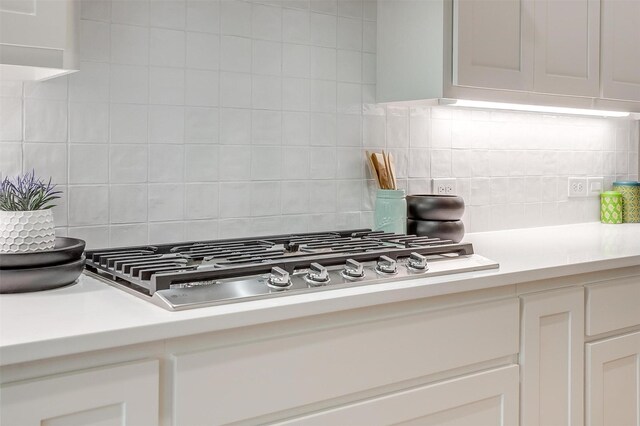 2000 Cumberland Cir, Corsicana, TX 75110 - kitchen featuring stainless steel gas stovetop, light countertops, tasteful backsplash, and white cabinets