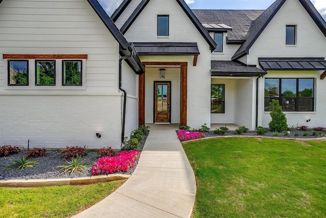 2000 Cumberland Cir, Corsicana, TX 75110 - view of front of property featuring a standing seam roof, brick siding, a front yard, and roof with shingles