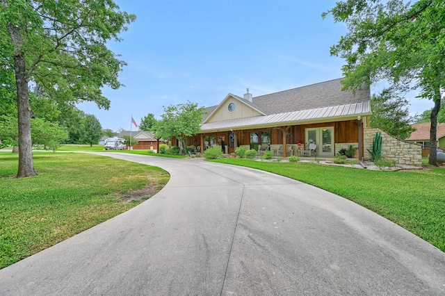 206 Pueblo Dr E, Lake Kiowa, TX 76240 - view of front facade with curved driveway, a chimney, covered porch, and a front yard