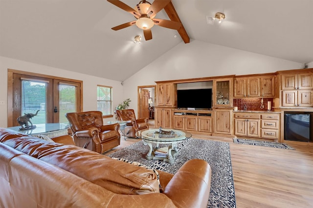 206 Pueblo Dr E, Lake Kiowa, TX 76240 - living area with beam ceiling, light wood-style floors, high vaulted ceiling, french doors, and a ceiling fan