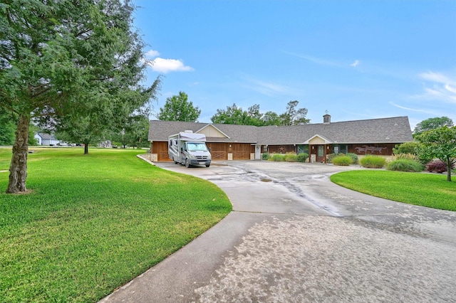 206 Pueblo Dr E, Lake Kiowa, TX 76240 - ranch-style house featuring curved driveway, a chimney, and a front lawn