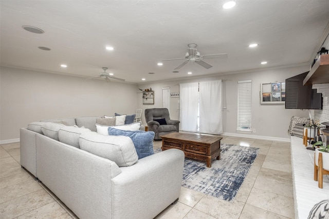 tiled living room with ornamental molding and ceiling fan