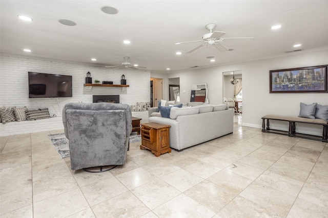 tiled living room with ornamental molding, brick wall, and ceiling fan