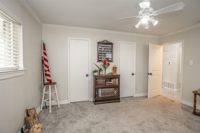 bedroom featuring crown molding, light colored carpet, and ceiling fan