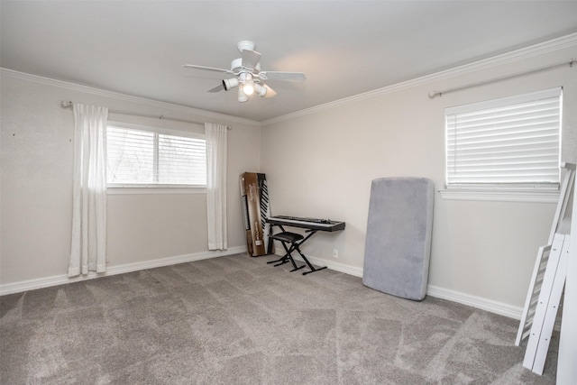 carpeted empty room with crown molding and ceiling fan