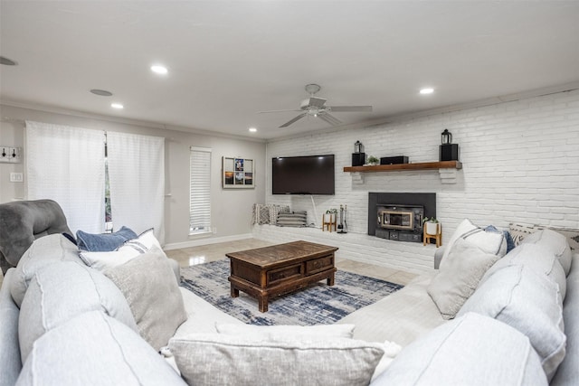 living room with ceiling fan, brick wall, and ornamental molding