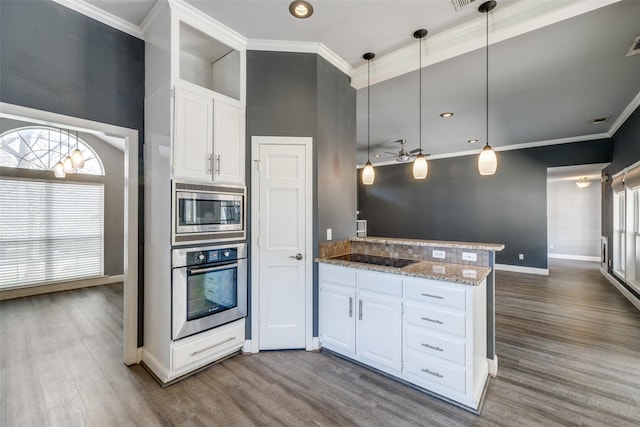 kitchen with pendant lighting, ornamental molding, stainless steel appliances, and white cabinets