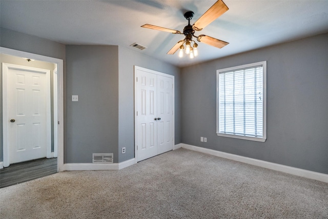 unfurnished bedroom featuring ceiling fan, carpet flooring, and a closet