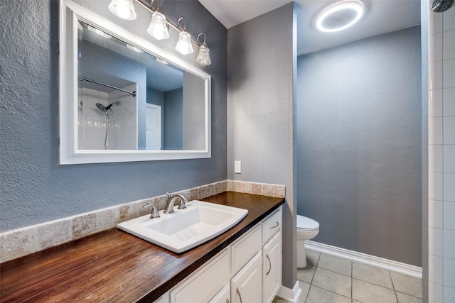 bathroom featuring vanity, tile patterned floors, and toilet