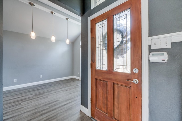 entryway with vaulted ceiling and dark wood-type flooring