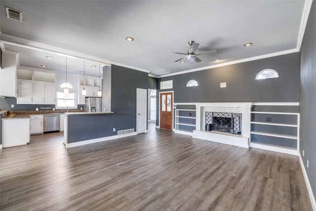 unfurnished living room with crown molding, ceiling fan, dark hardwood / wood-style flooring, and sink