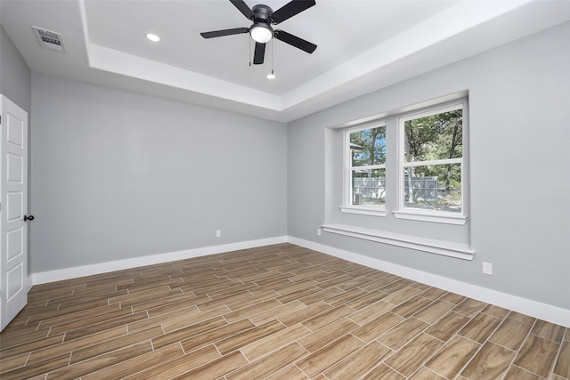 11298 Cedar Dr, Mabank, TX 75156 - empty room featuring a tray ceiling, wood finished floors, baseboards, ceiling fan, and recessed lighting