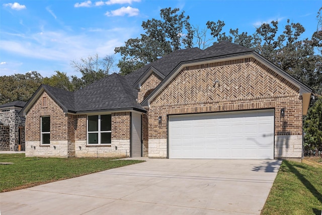11298 Cedar Dr, Mabank, TX 75156 - french country style house featuring concrete driveway, brick siding, roof with shingles, stone siding, and an attached garage