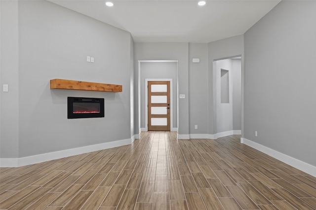 11298 Cedar Dr, Mabank, TX 75156 - entryway featuring a glass covered fireplace, wood finished floors, baseboards, and recessed lighting