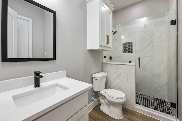 bathroom with vanity, an enclosed shower, and toilet