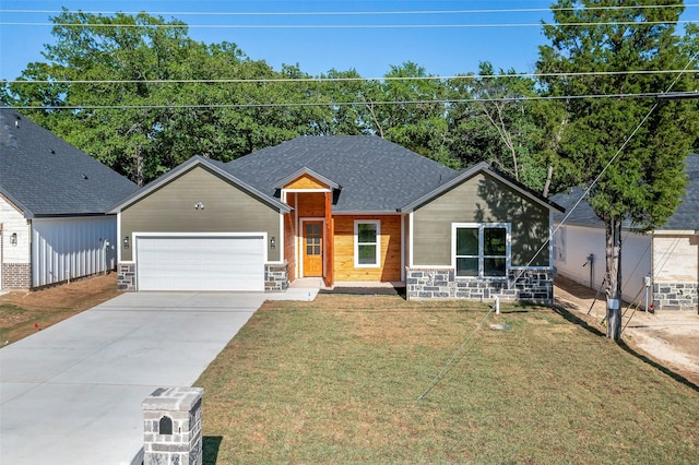 view of front facade with a garage and a front lawn