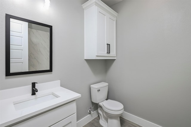 bathroom featuring hardwood / wood-style flooring, vanity, and toilet